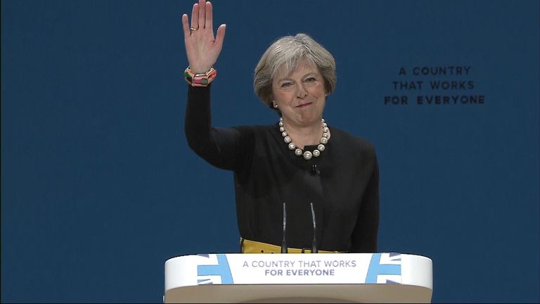 Theresa May waves after delivering her first Tory conference speech as party leader. 