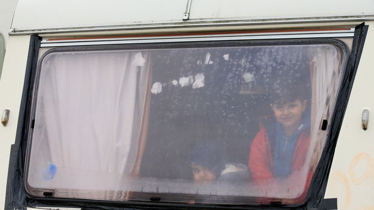 Two migrants childs from Irak look through the window in the southern part of a camp for migrants called the "jungle", in Calais, northern France, February 25, 2016. The administrative tribunal in regional capital Lille was to decide whether closing part of the site would violate human rights after several local charities and migrants requested a temporary injunction to halt the planned evacuation. REUTERS/Pascal Rossignol ATTENTION EDITORS - FRENCH LAW FORBIDS THE PUBLICATION OF FACES OF MINORS