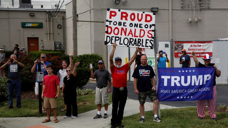 Supporters watch Donald Trump&#39;s motorcade arrive for a rally in High Point, North Carolina,