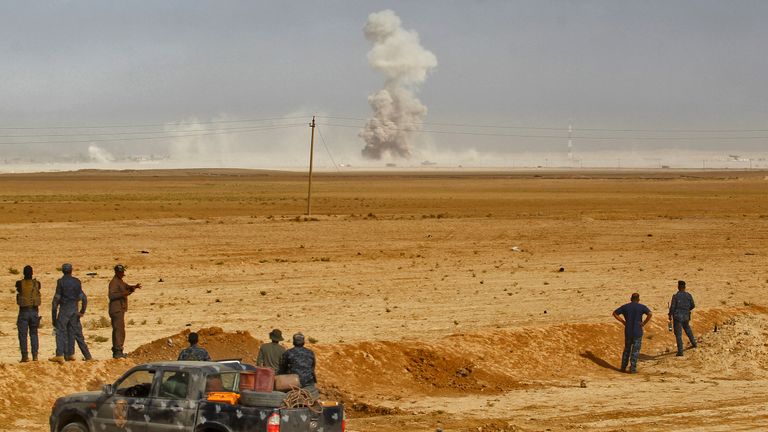 Smoke billows as Iraqi forces deploy in the area of al-Shurah
