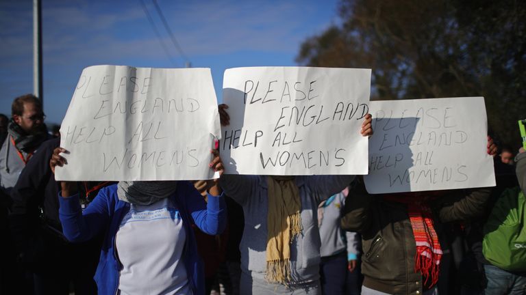 Women take part in a protest calling on the UK government to help women migrants of the &#39;Jungle&#39; camp before authorities demolish the site on October 25, 2016 in Calais, France.