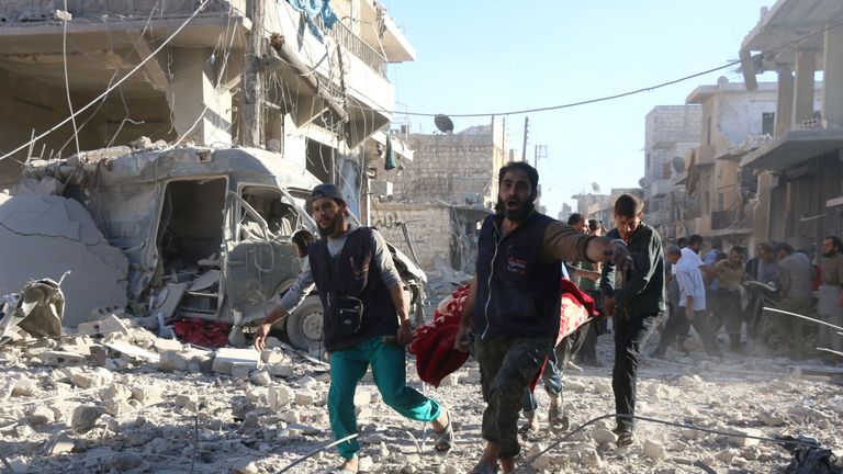 An injured person is carried on a stretcher after an airstrike in a rebel-held area of Aleppo on Friday
