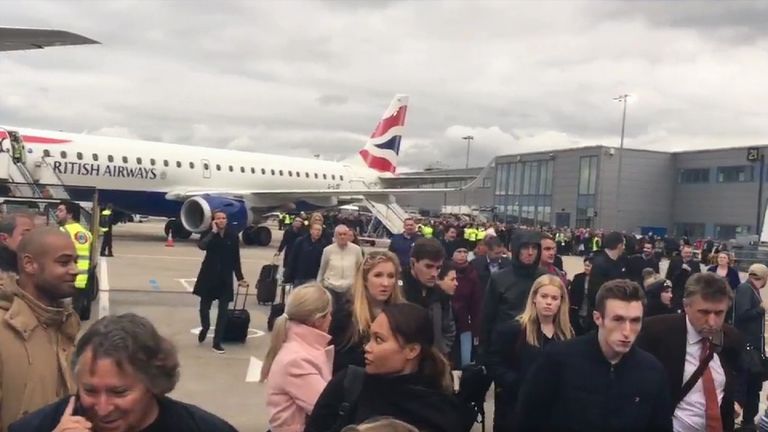 Passengers evacuating London City Airport after chemical incident