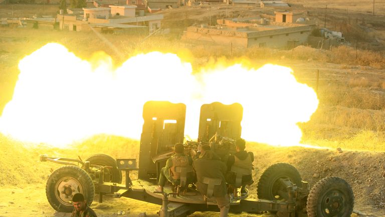 Peshmerga forces fire an anti-aircraft gun towards Islamic state militants positions in the town of Naweran near Mosul