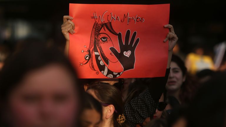 A woman holds a banner during a march in Santiago in Chile