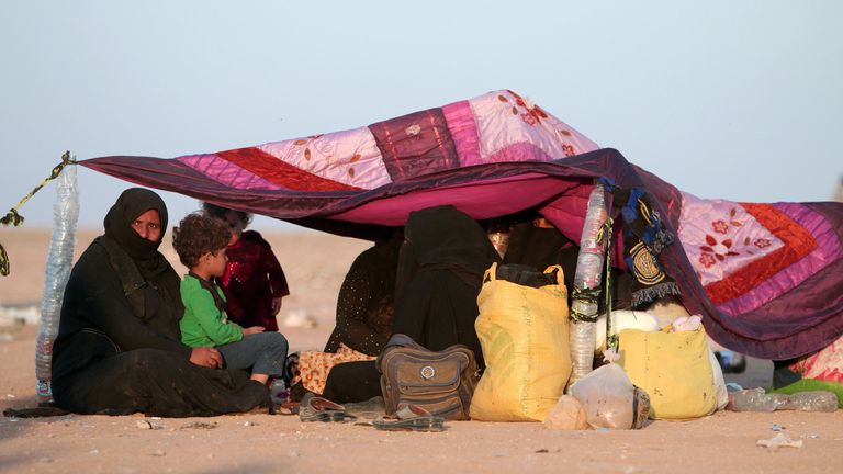 Iraqis who fled violence in Mosul rest under a makshift tent upon reaching Syria, near the Iraqi border, in Hasaka Governorate 
