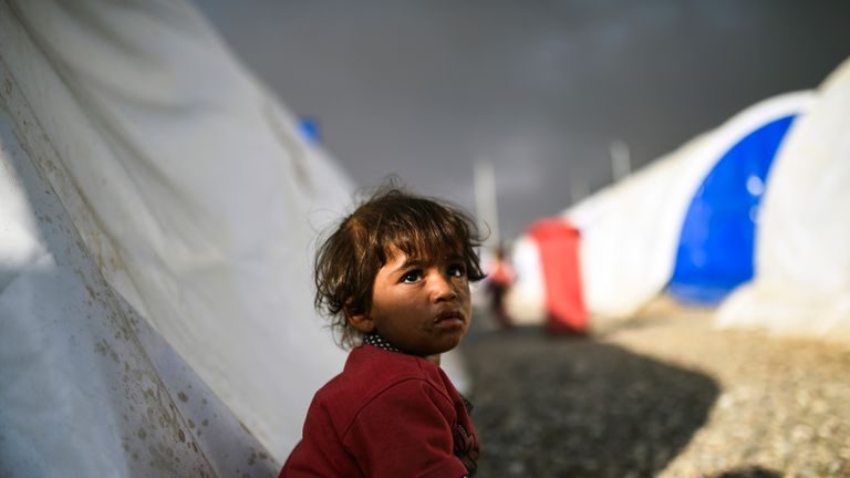 A displaced Iraqi girl looks on upon arriving to a refugee camp on October 22, 2016 in the town of Qayyarah, south of Mosul, as an operation to recapture the city of Mosul from the Islamic State group takes place
