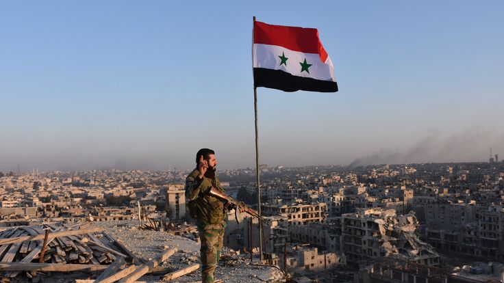 A pro-government fighter overlooks Aleppo in the city&#39;s Bustan al Basha neighbourhood