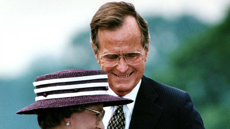 US President George Bush steps aside 14 May 1991 for Great Britain's Queen Elizabeth II to address the crowd attending a welcoming ceremony at the White House, in Washington, DC. During his remarks, President Bush addressed the queen, saying, 'You have been freedom's friend for as long as we remember.' (Photo credit should read JEROME DELAY/AFP/Getty Images)
