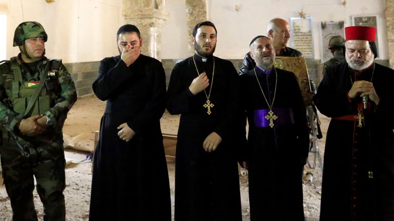 Priests at the Mart Shoomy Church in Bahzani survey to destruction carried out by IS