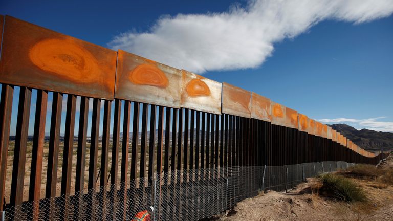 A U.S. worker inspects a section of the U.S.-Mexico border wall at Sunland Park, US