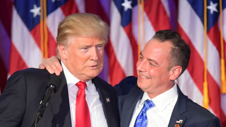 Reince Priebus (R) hugs Donald Trump on election night
