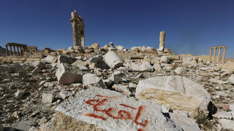 IS graffiti reads "we remain" after Syrian troops recapture the ancient site of Palmyra 