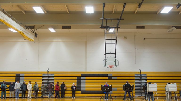 FLORISSANT, MO - NOVEMBER 08: Voters wait in line to cast their ballots at Hazelwood Central High School on November 8, 2016 in Florissant, Missouri. Americans today will choose between Republican presidential candidate Donald Trump and Democratic presidential candidate Hillary Clinton as they go to the polls to vote for the next president of the United States. (Photo by Michael B. Thomas/Getty Images)