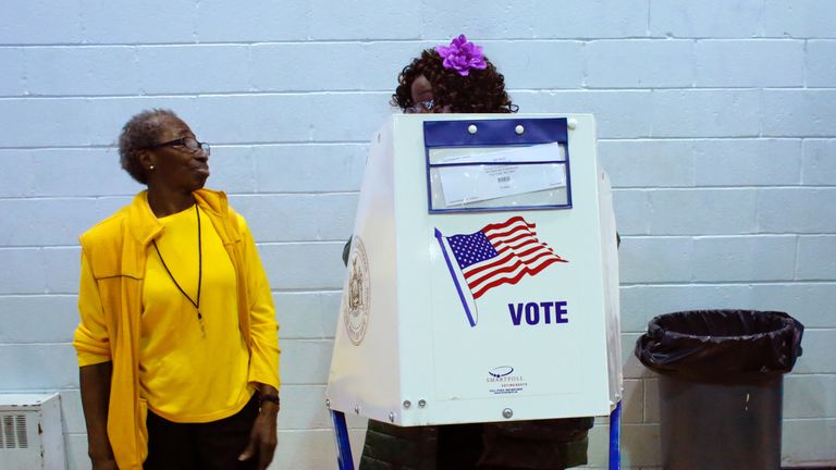 A voter asks an election worker a question as she votes at Samuels Community Center in the presidential election November 8, 2016 in the Harlem neighborhood of New York City. / AFP / KENA BETANCUR (Photo credit should read KENA BETANCUR/AFP/Getty Images)