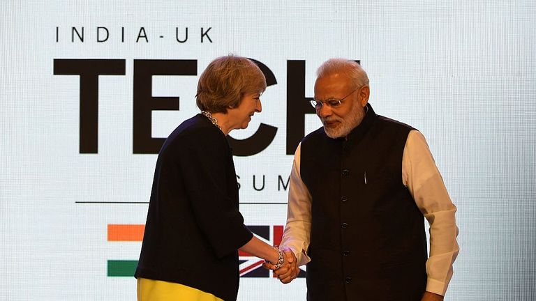 Theresa May shakes hands with Narendra Modi in Delhi