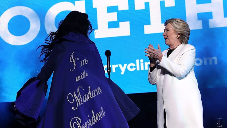 PHILADELPHIA, PA - NOVEMBER 05: Democratic presidential nominee former Secretary of State Hillary Clinton (R) looks at a cape worn by recording artist Katy Perry (L) during a get-out-the-vote concert at the Mann Center for the Performing Arts on November 5, 2016 in Philadelphia, Pennsylvania. With three days to go until election day, Hillary Clinton is campaigning in Florida and Pennsylvania. (Photo by Justin Sullivan/Getty Images)
