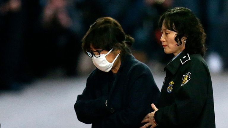 Choi Soon-Sil being escorted following her formal arrest