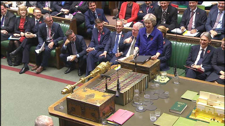 Sir Patrick McLoughlin, to Theresa May's right draws his thumb across his throat