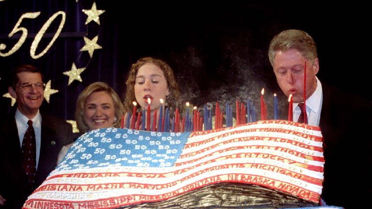 Chelsea helps dad blow out his 50th birthday cake candles in 1996