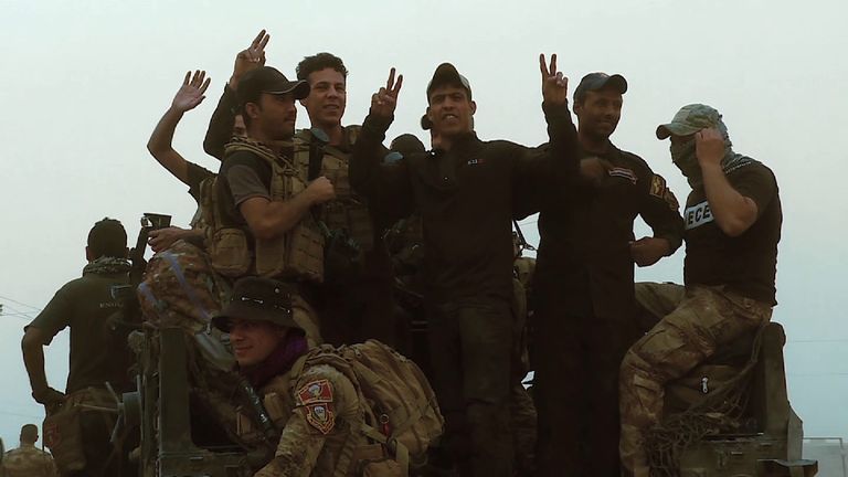 Iraqi Golden Division soldiers give V signs after advancing towards Mosul