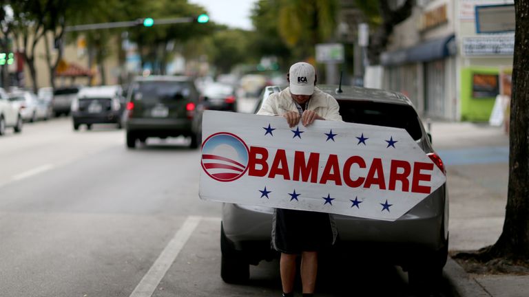 Man with Obamacare sign