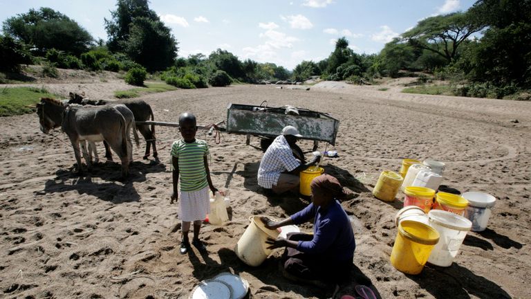Villagers collect water from a dry river bed in Masvingo, Zimbabwe in June