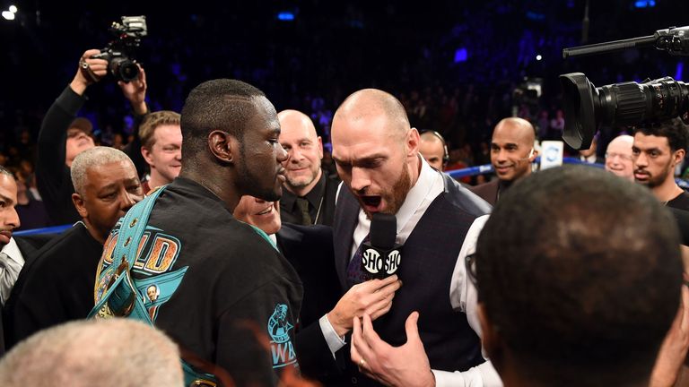 Tyson Fury of Britain (R) challeges Deontay Wilder of the US (L) after Wilder defeated Artur Szpilka of Poland in their WBC Heavyweight Championship bout a