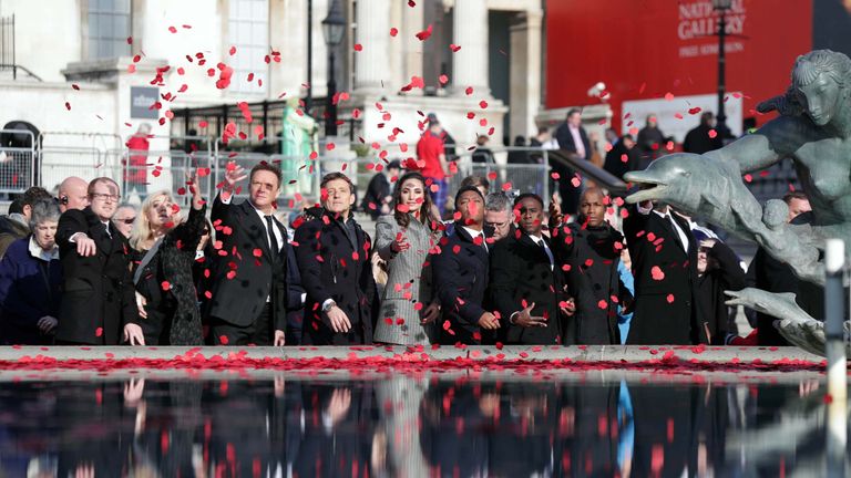 Poppies are thrown into fountains after a service in Trafalgar Square, London