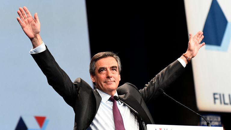 Candidate for the right-wing Les Republicains (LR) party primaries ahead of the 2017 presidential election and former French prime minister Francois Fillon raises his arms as he speaks during a meeting on November 18, 2016 in Paris. / AFP / BERTRAND GUAY (Photo credit should read BERTRAND GUAY/AFP/Getty Images)
