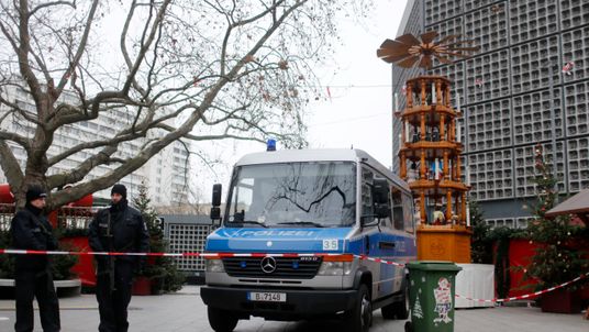 Police stand guard at the site of the Christmas market in Berlin