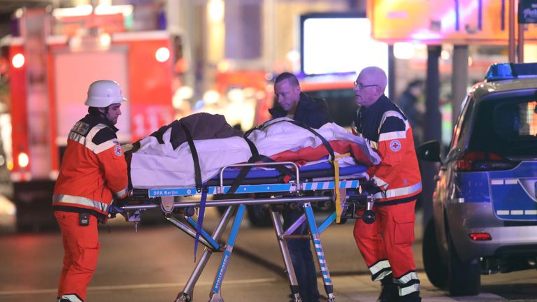 A person injured when a lorry crashed into a Christmas market is taken to hospital by paramedics