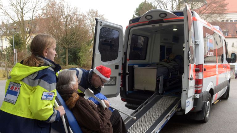 An elderly resident is evacuated from Augsberg by paramedics