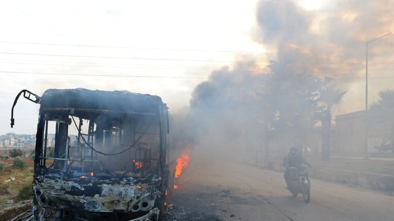 A bus burning as it made its way to evacuate people from besieged cities