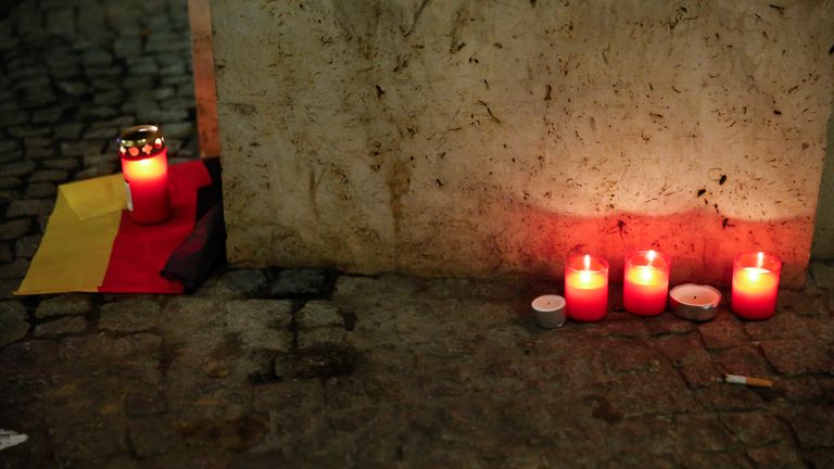 Candles are left close to the scene where at least 12 people died as a lorry crashed into a Christmas market