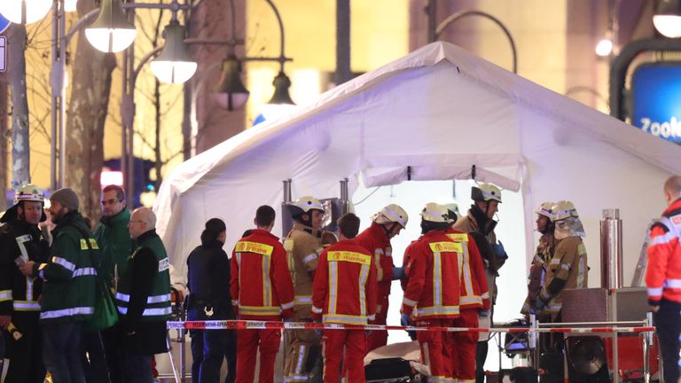 Rescue workers gather with stretchers outside a tent in the area after a lorry truck ploughed through a Christmas market on December 19, 2016 in Berlin, Germany.

