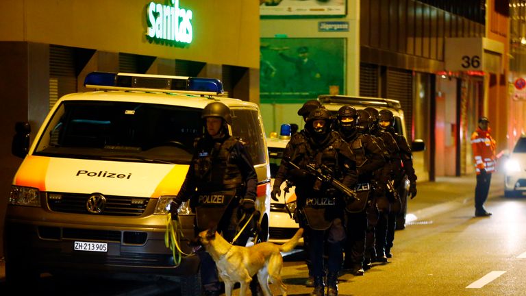Police stand outside an Islamic center in central Zurich, Switzerland December 19, 2016