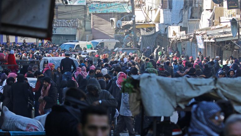 People gather to be evacuated from a rebel-held sector of eastern Aleppo