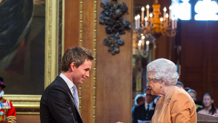 Eddie Redmayne receiving his OBE from the Queen