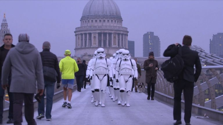Fans dressed as Imperial stormtroopers march across London for a private screening of Rogue One: A Star Wars Story.