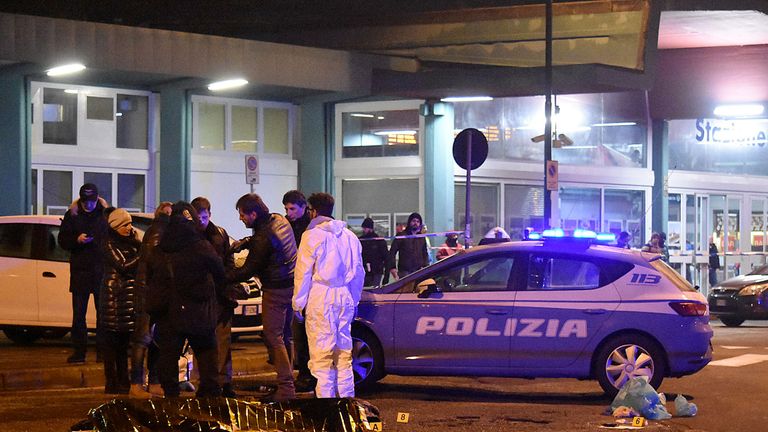 Italian police and forensics experts gather around the body of suspected Berlin truck attacker Anis Amri in Milan