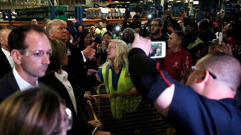 The President-elect is surrounded by factory workers