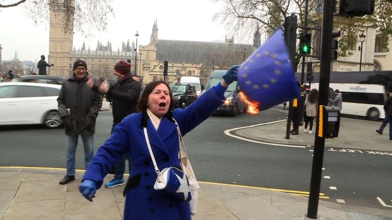 A protester burns an EU flag outside the Supreme Court in London. 