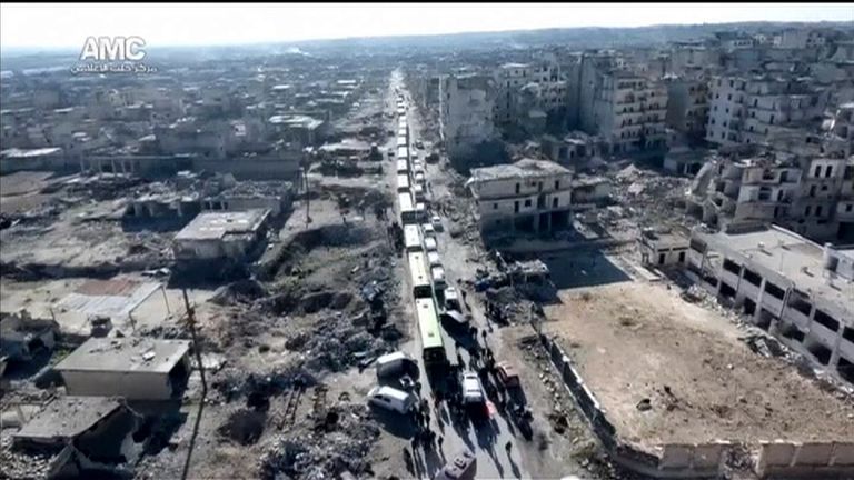 A convoy leaves Aleppo in Syria