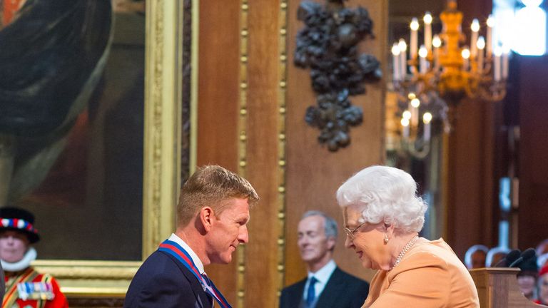 Major Tim Peake receiving his honour from the Queen