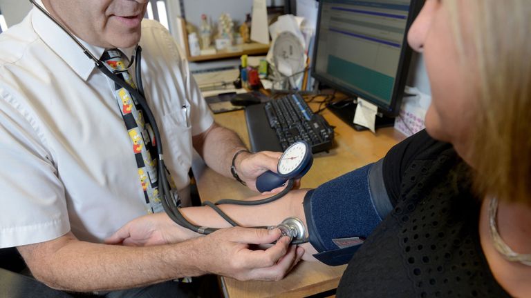 A doctor checks a patient&#39;s blood pressure