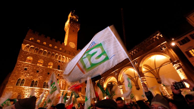 Supporters wave flags as Italian Prime Minister Matteo Renzi speaks during the last rally for a &#34;Yes&#34; vote