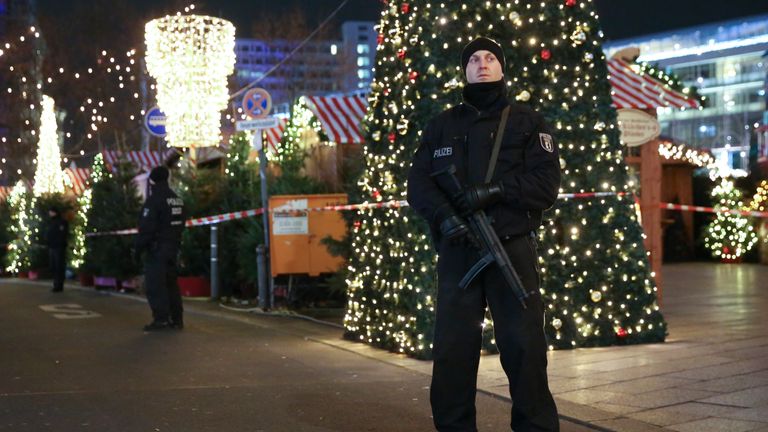 Police patrol the area where a lorry killed at least nine people at a Christmas market in Berlin