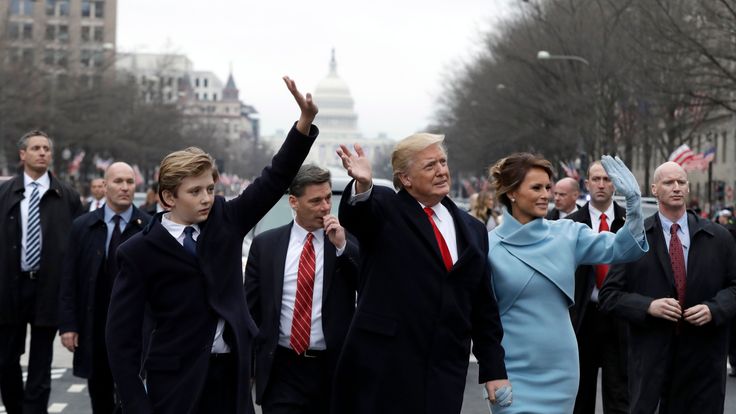 Donald Trump and his family walk down Pennsylvania Avenue to the White House