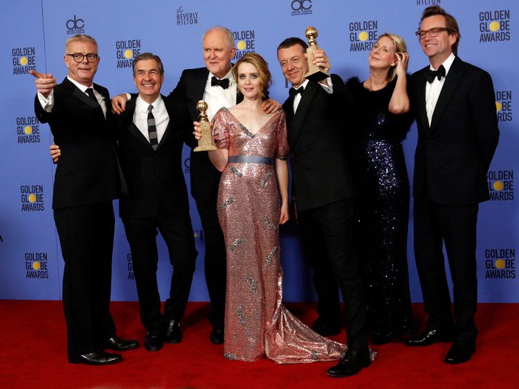 The cast and crew of "The Crown" pose together after winning the award for Best Television Series - Drama as star Claire Foy holds her award for Best Performance by an Actress In A Television Series - Drama during the 74th Annual Golden Globe Awards in Beverly Hills, California, U.S., January 8, 2017